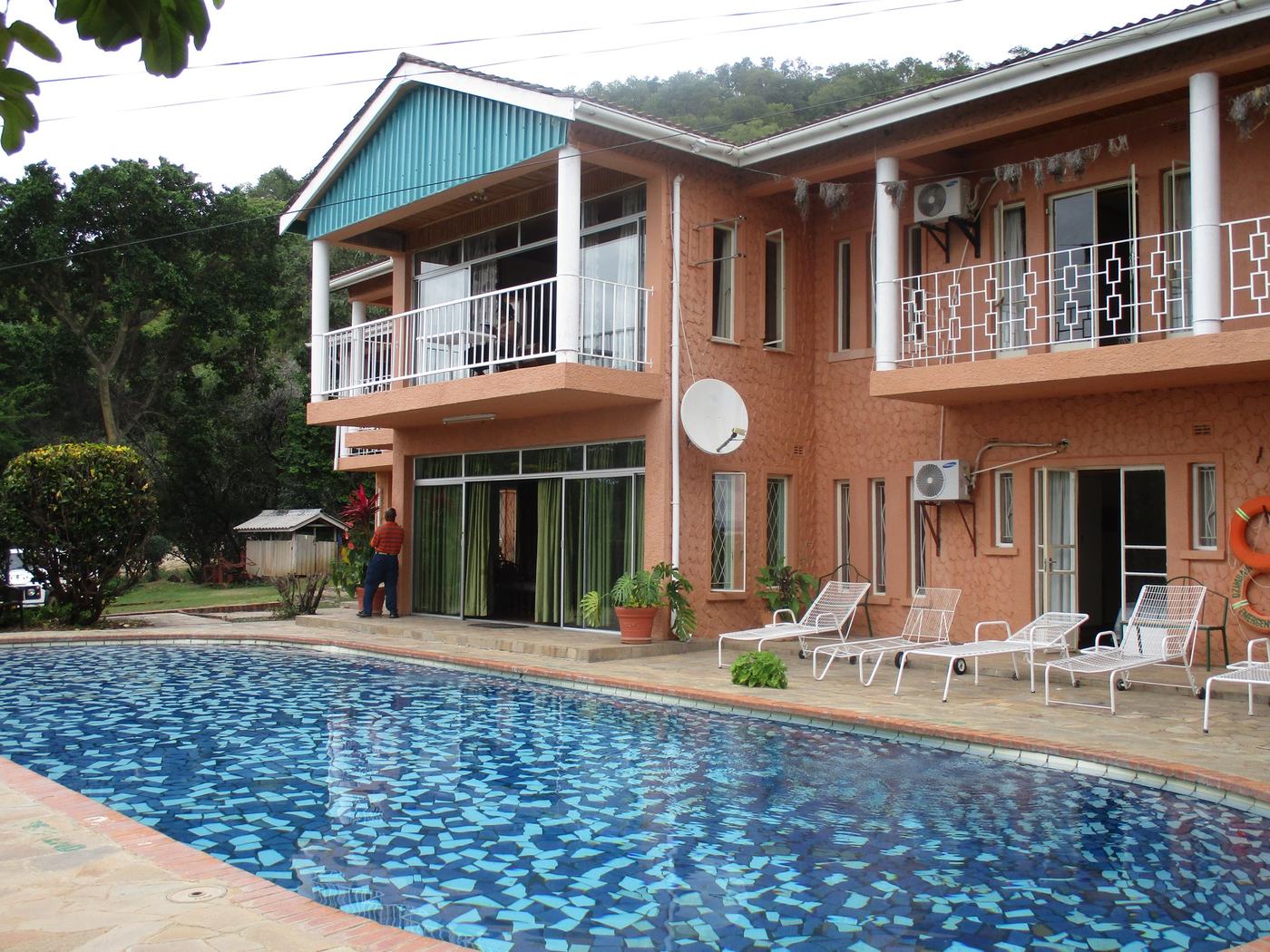 Two-storey lodge wing overlooks the pool and loungers at Dzimbabwe Lodge, Matusadona.