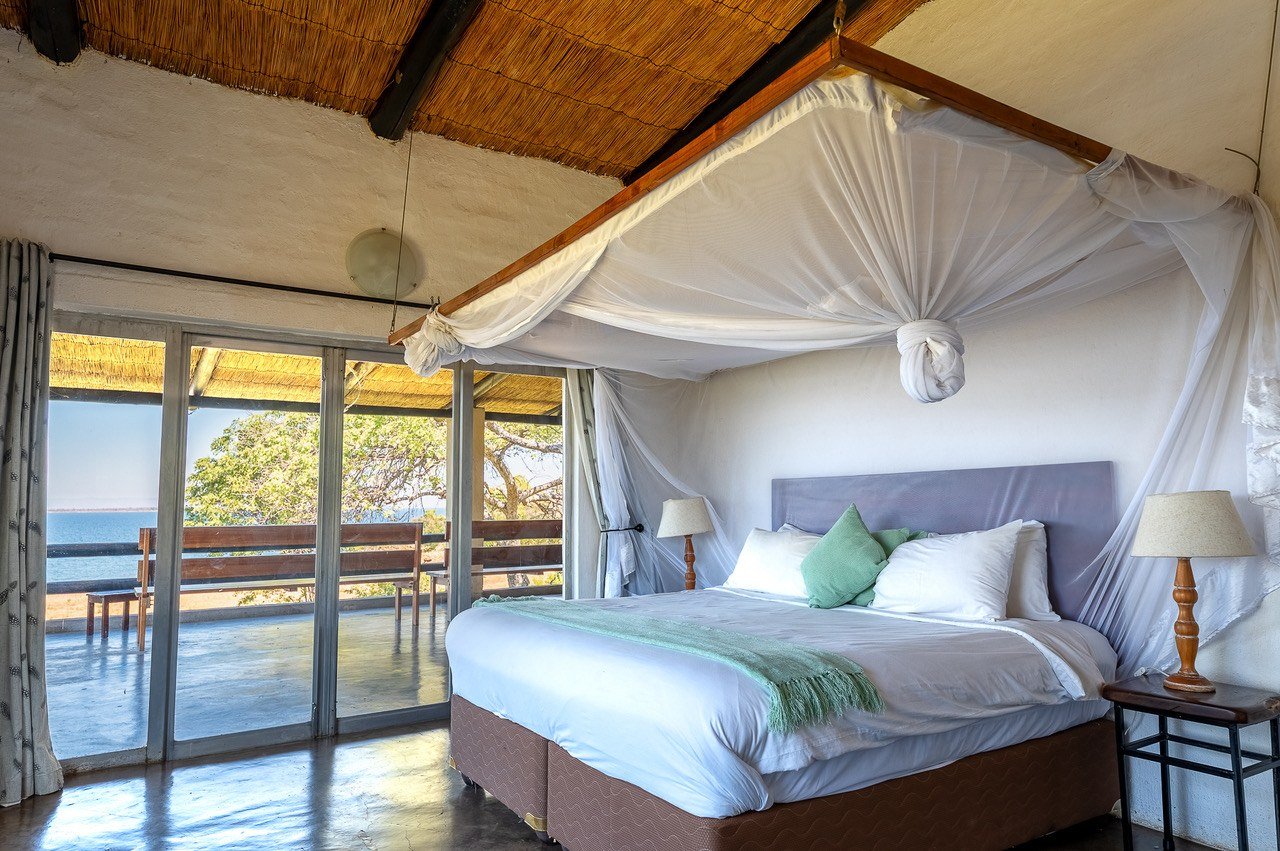 Canopied bed opens onto a balcony overlooking the lake at Fisherman's Cove.