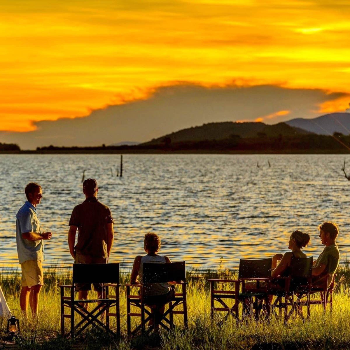 Guests gather for sundowners beside the lake from MV Matusadona.