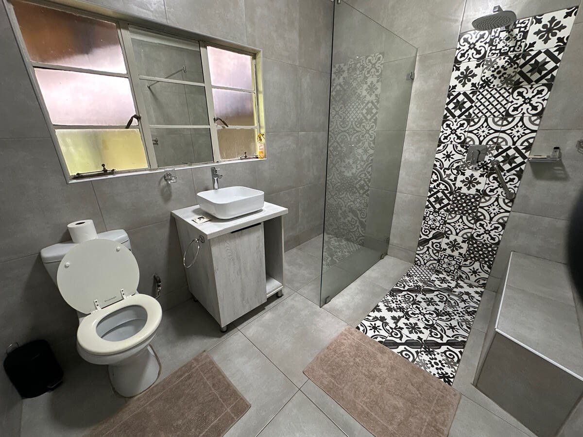 Modern bathroom with a patterned tile shower at Spurwing Island.