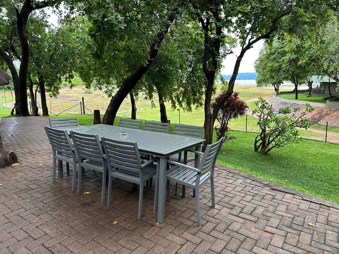 Outdoor dining table under umbrellas on the lawn at Spurwing Island.